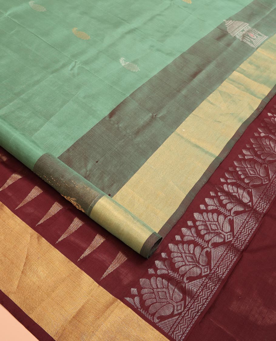 Green Uppada Silk Saree Accentuated with Paisley Buttas, Subtle Contrast Border of Temple Gopuram Motifs, Captivating Pallu Featuring Floral Jaal Design, and Paired with a Contrast Blouse