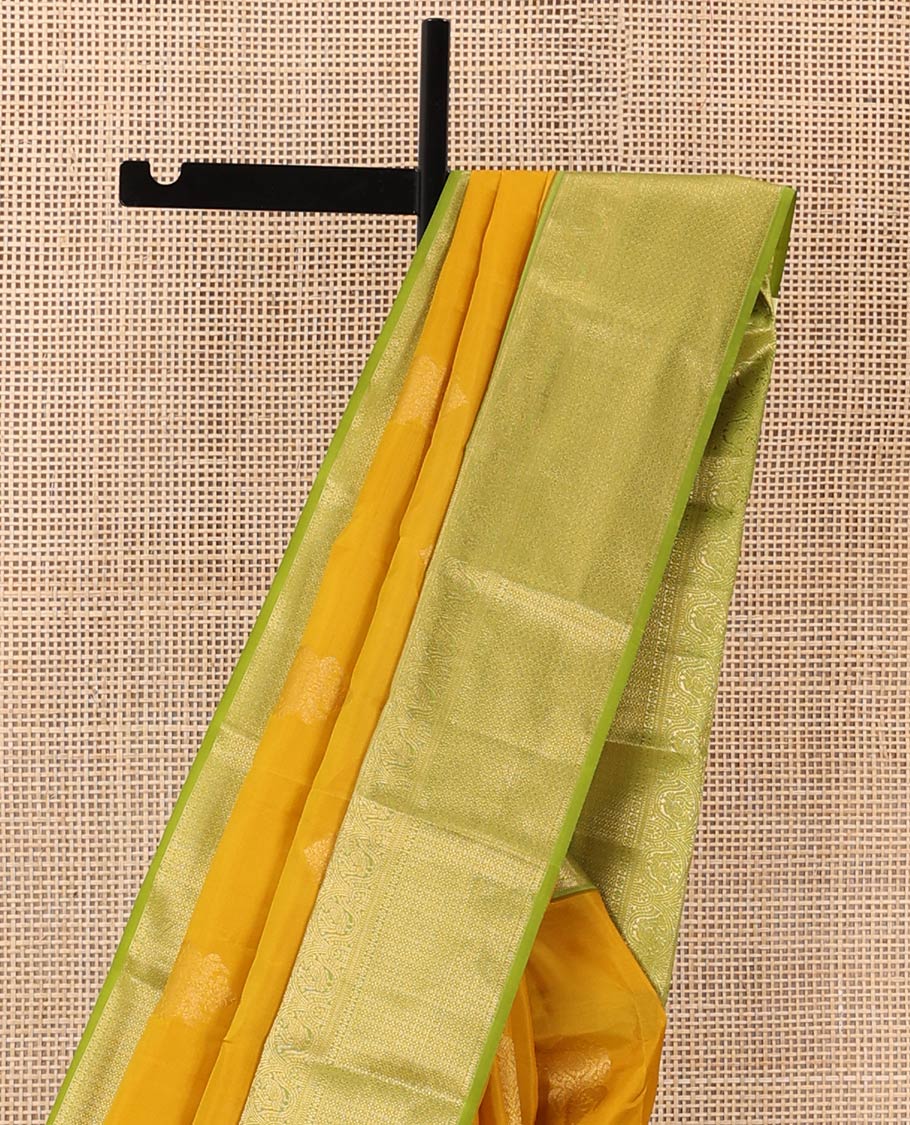 Yellow zari buttas Vasundhara silk mix saree, contrast border of muthu, mayil, kamalam, jaal designs, and pallu of kodi visiry designs