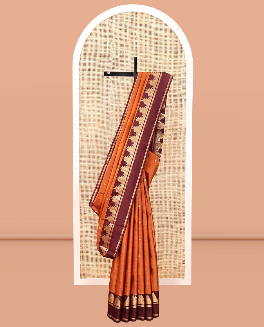 Orange Vasundhara Silk Saree, Delicately Woven with Zari Buttas, Complemented by a Contrast Rettai Pettu Border of Thazampoo Rekku Designs, Vanki Pallu, and a Contrast Blouse