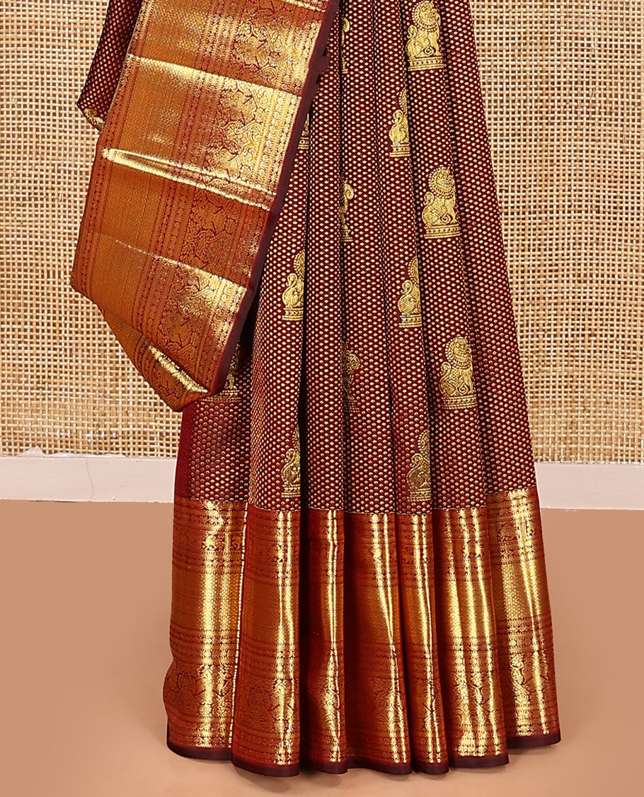 Maroon singam buttas woven kanchipuram silk saree, zari border of muthu, banaras, manga kodi, yaali, kuthirai, yaanai, mayil kann, rudraksham, and iruthalai pakshi, and jaal pallu