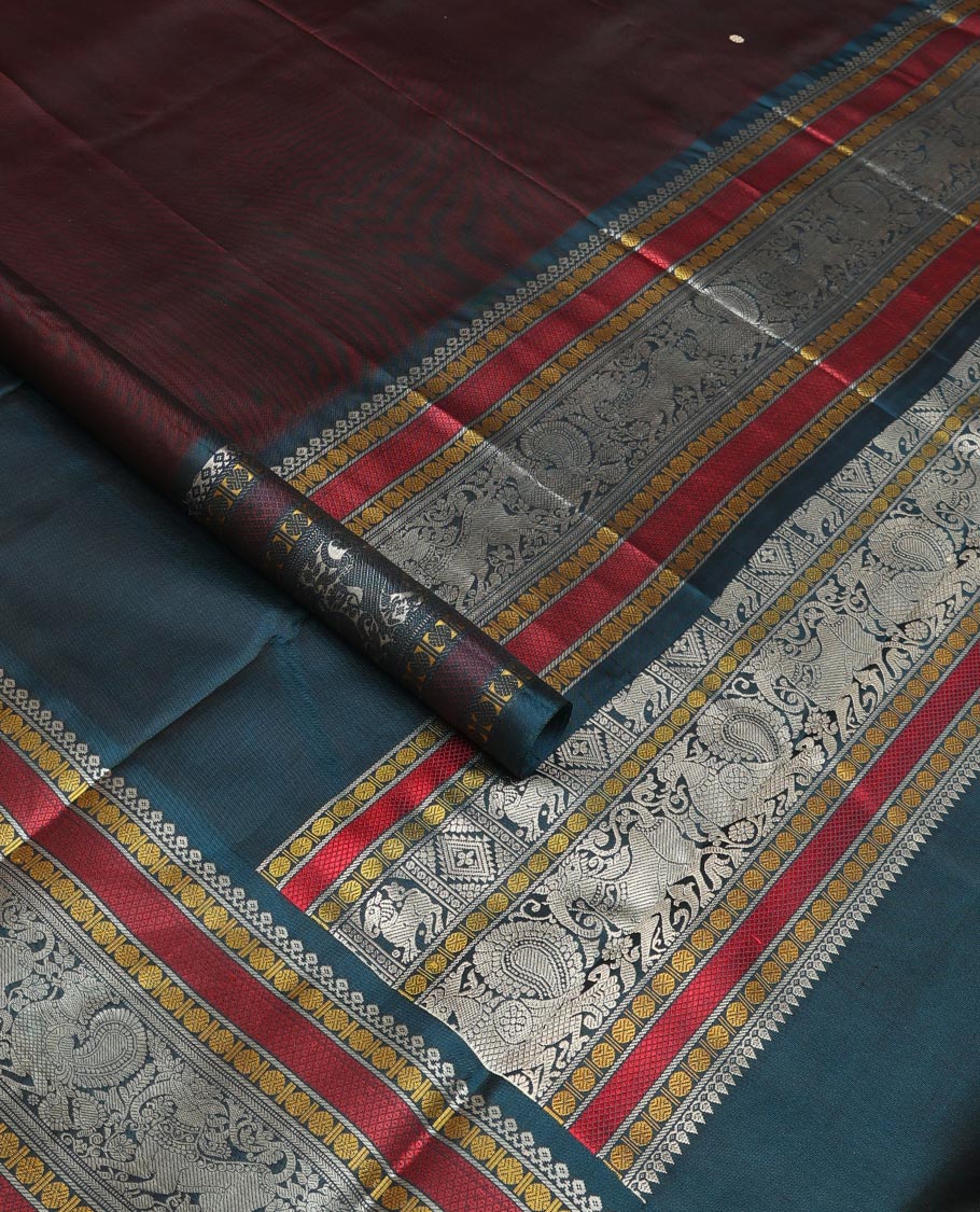 Brown mayil chakram thread buttas Kanchipuram silk saree, contrast border of thilakam mokku, mayil, yaali, and rudraksham, and pallu of big Nava Nari Kunjara motif