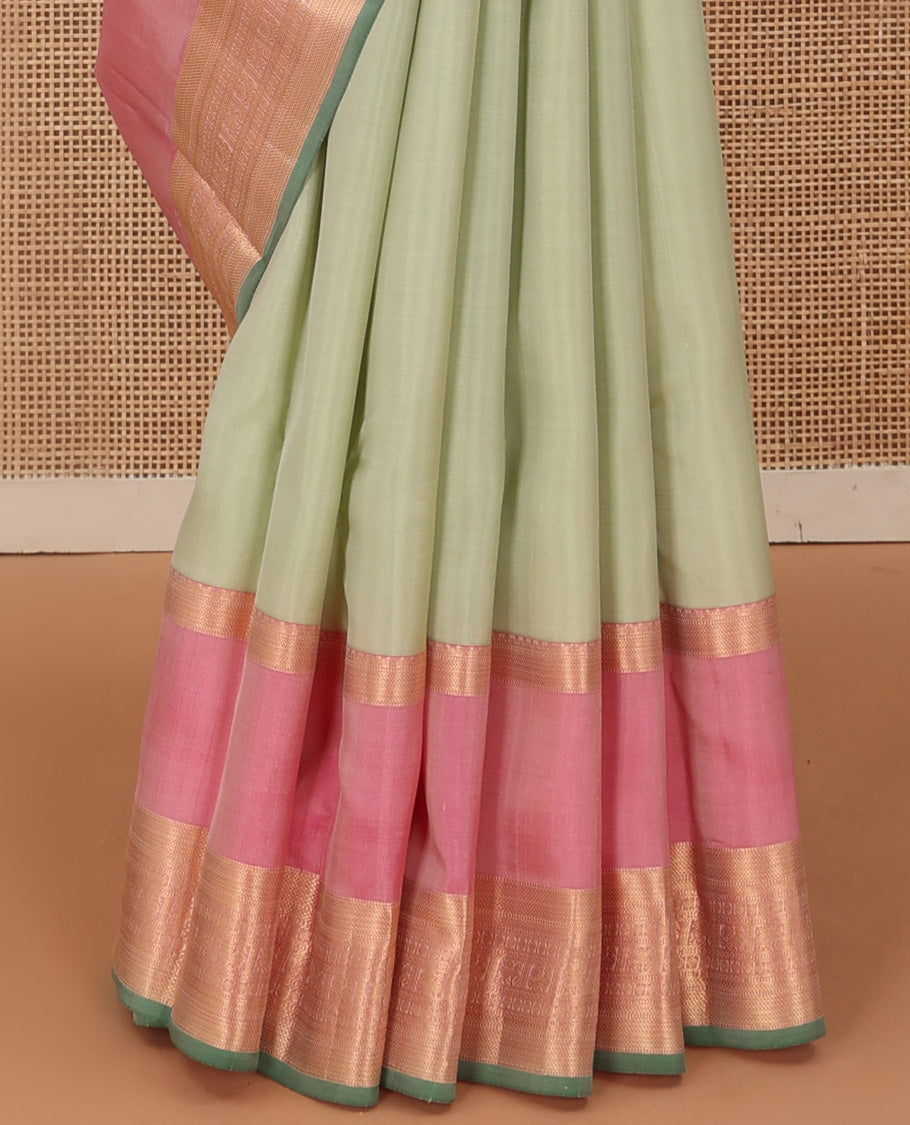 Tea green plain Kanchipuram silk saree, contrast rettai pettu border of muthu, kathir, kuyil kann,rudraksham, mayil, and kuthirai designs, and mayil kann pallu
