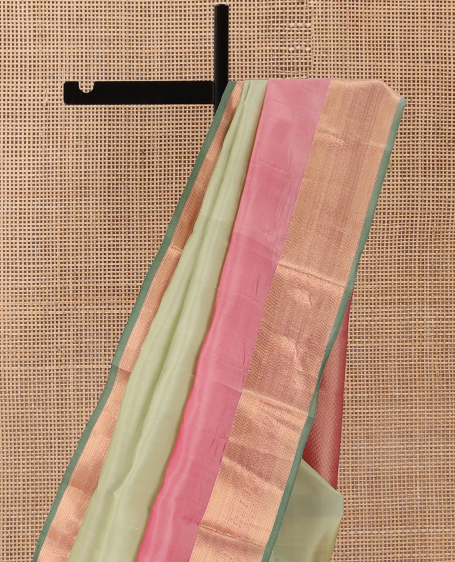 Tea green plain Kanchipuram silk saree, contrast rettai pettu border of muthu, kathir, kuyil kann,rudraksham, mayil, and kuthirai designs, and mayil kann pallu