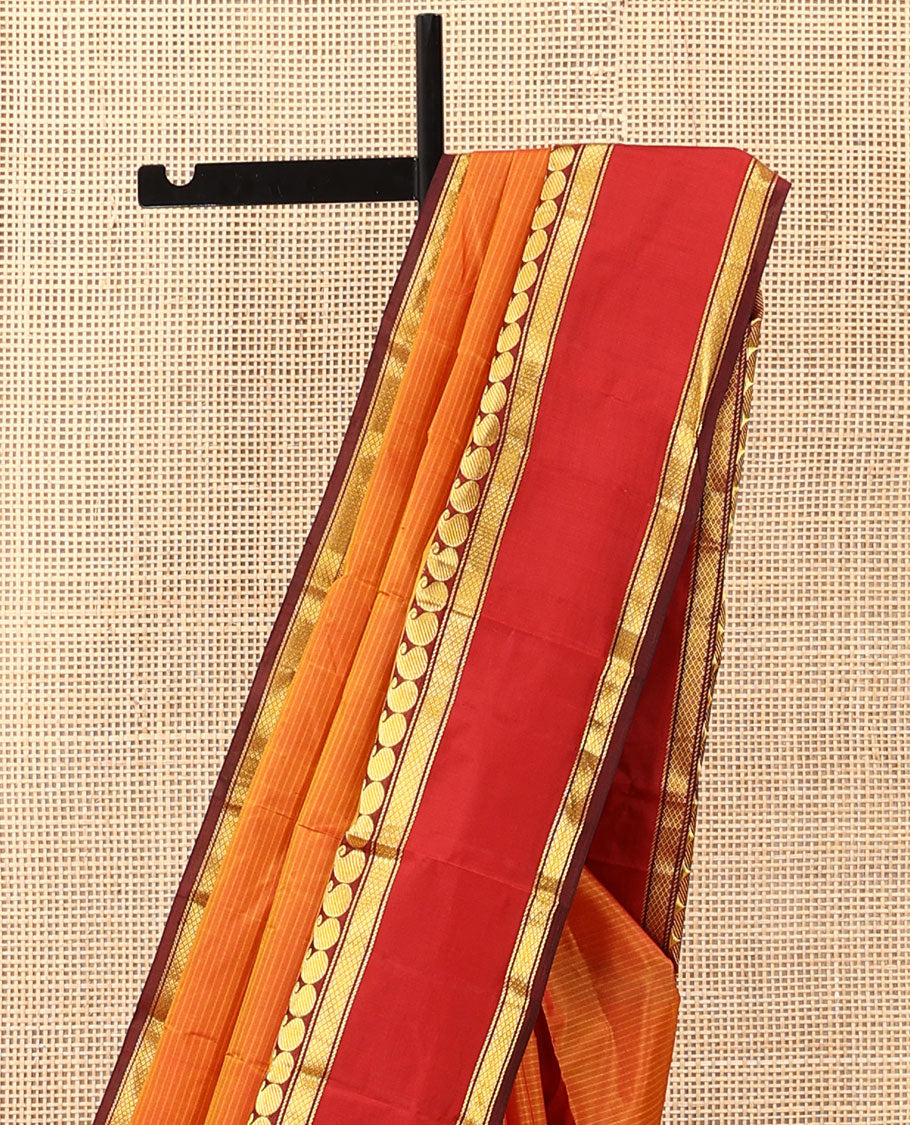 Orange striped Kanchipuram silk saree, contrast rettai pettu border of manga and mayil kann designs, and zari striped pallu