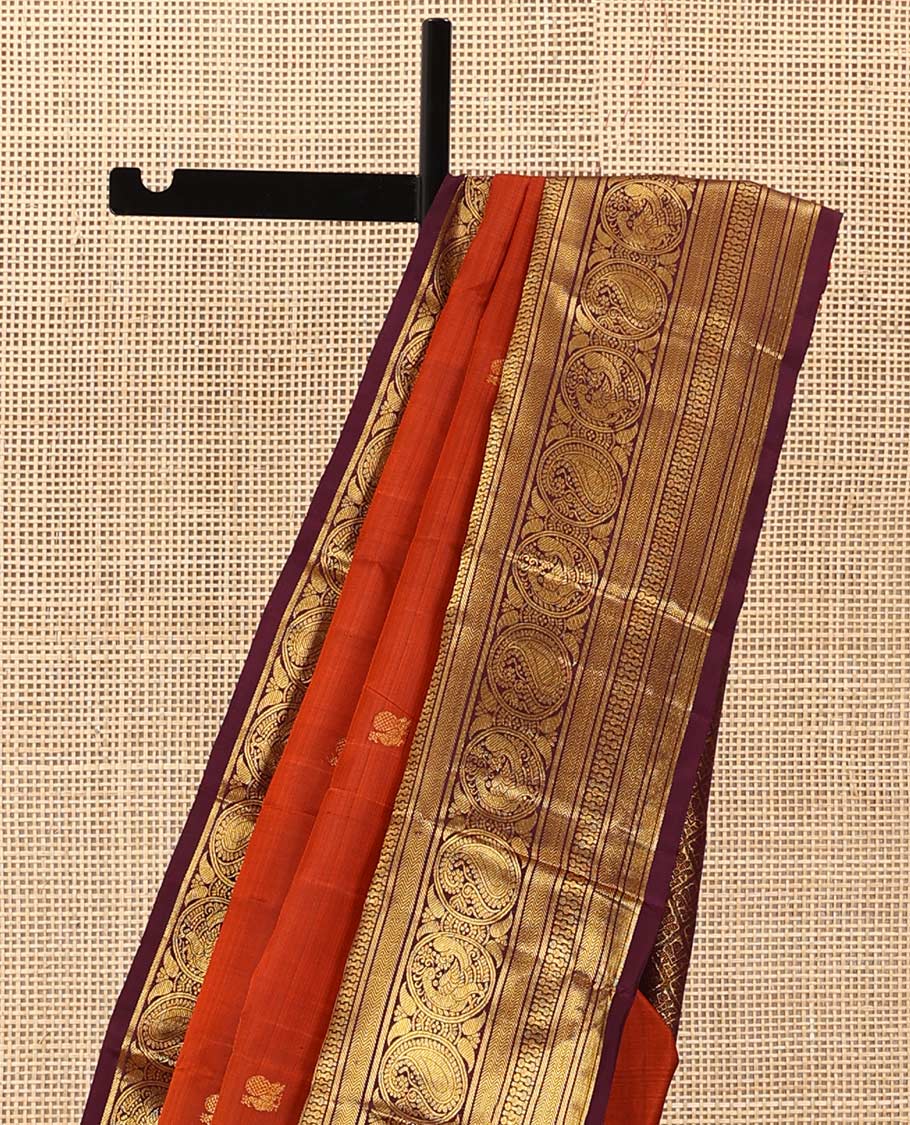 Orange annam chakram buttas Kanchipuram silk saree, contrast border of rekku, banaras, vanki, round mayil, and round manga, and jaal pallu