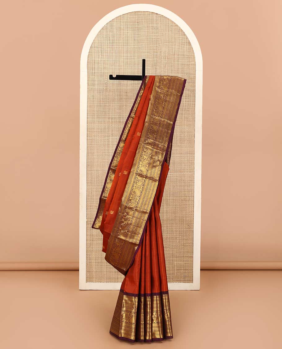 Orange annam chakram buttas Kanchipuram silk saree, contrast border of rekku, banaras, vanki, round mayil, and round manga, and jaal pallu