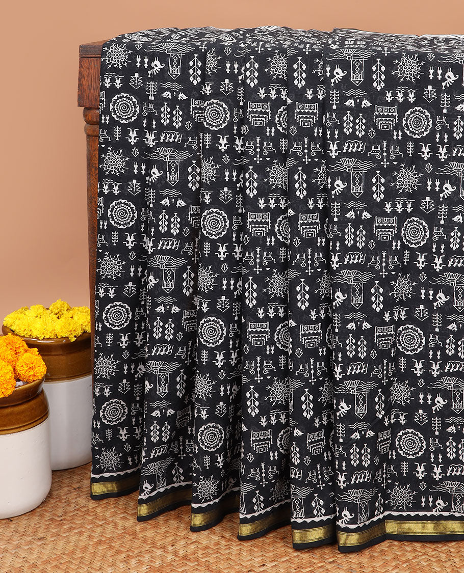 Black worli printed mul mul soft cotton saree with gold zari piping border & worli printed pallu along with bandhini printed blouse