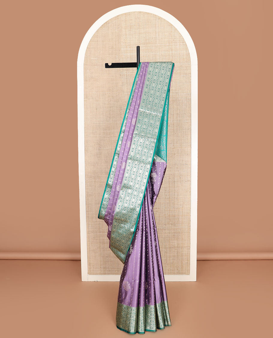 Purple floral buttas soft silk saree, contrast traditional zari design border, and pallu of geometric patterns