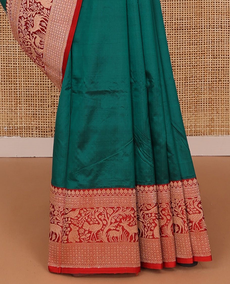 Green floral buttas katan silk saree, contrast traditional border of flora-fauna designs, and pallu of peacock, and derr motifs enclosed circles