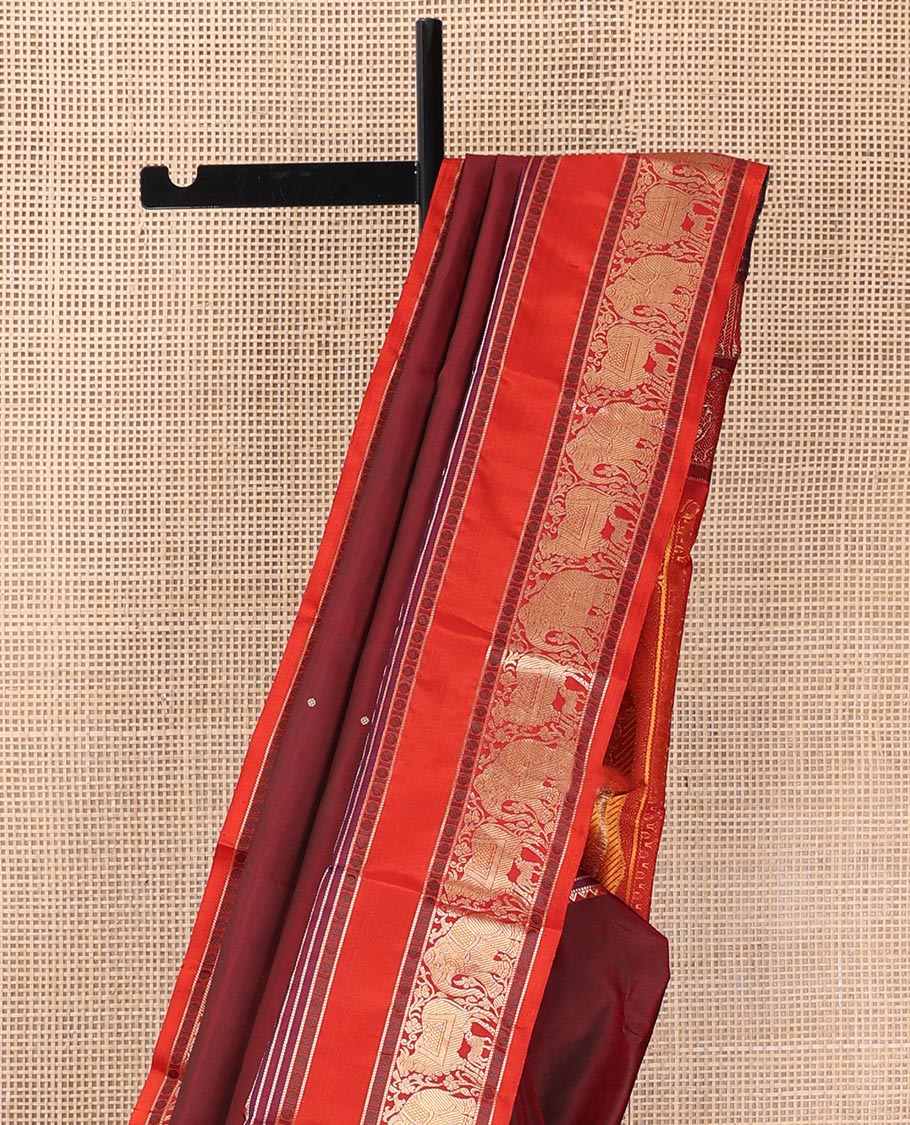 Maroon thread buttas Kanchipuram silk saree, contrast rettai pettu border of rekku, rudraksham, yaanai, and Pichwai cow designs, and pallu features Vrishabha Kunjara design