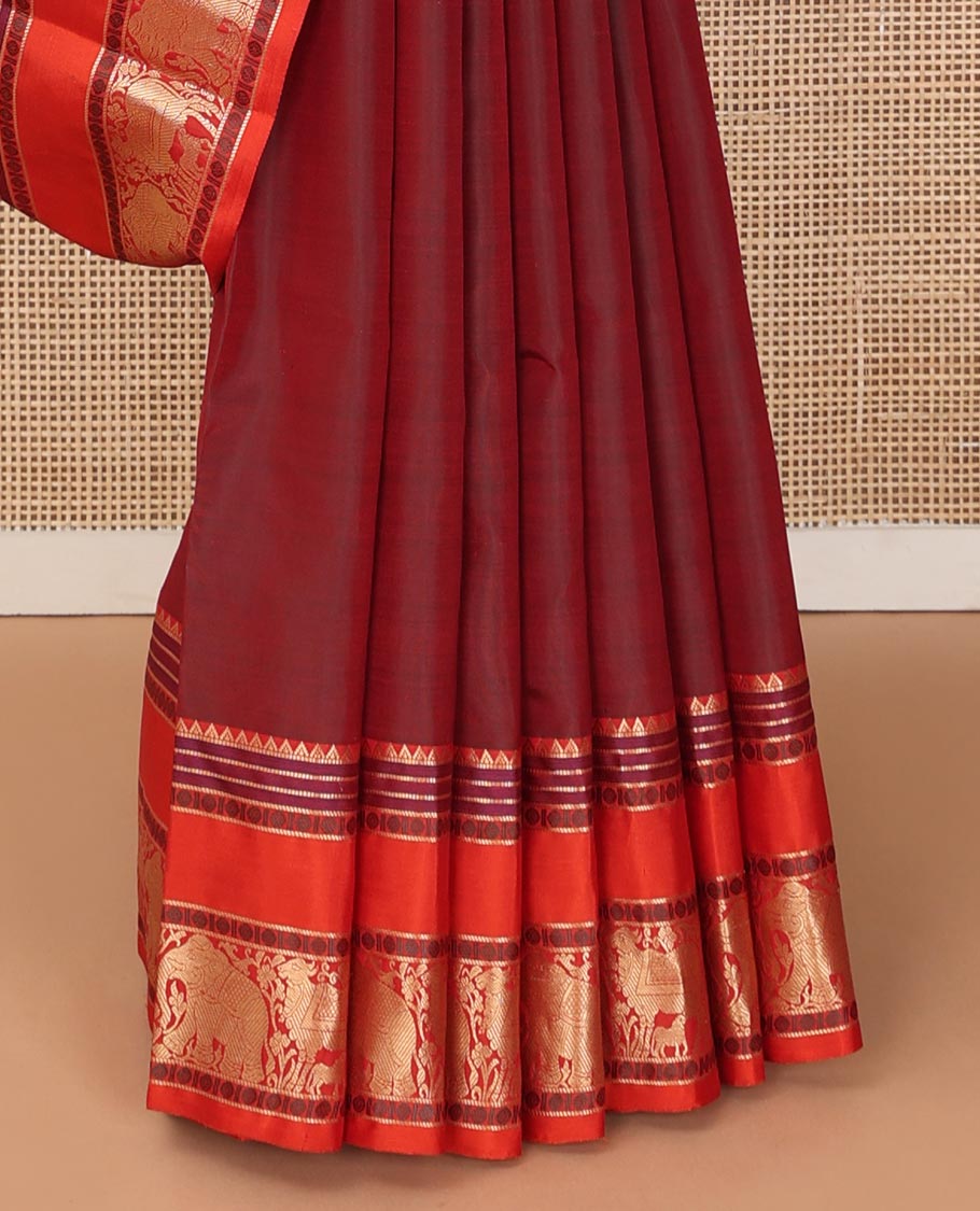 Maroon thread buttas Kanchipuram silk saree, contrast rettai pettu border of rekku, rudraksham, yaanai, and Pichwai cow designs, and pallu features Vrishabha Kunjara design