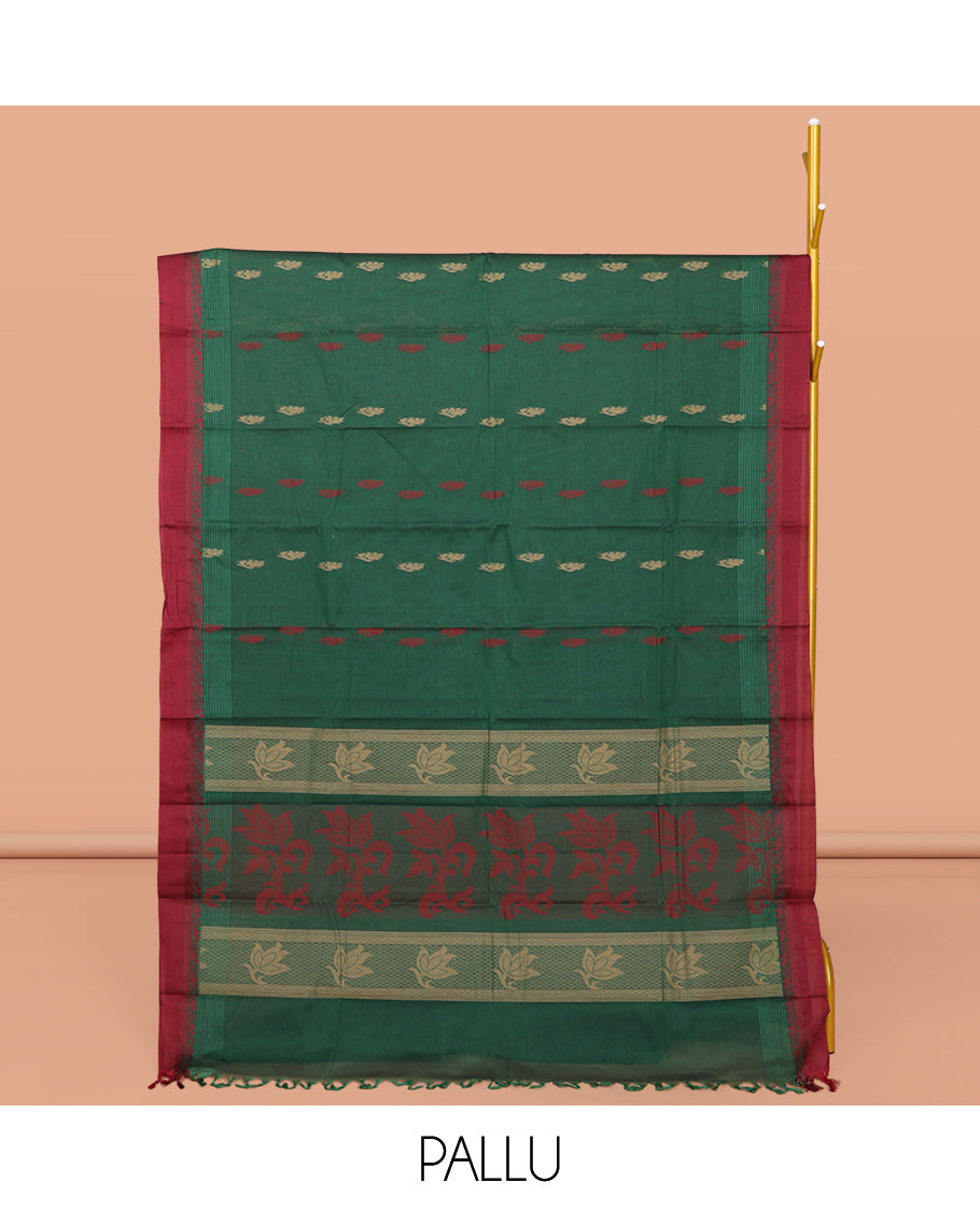 Green Kanchi Cotton Saree, Accentuated with Buttas All Over Its Body, Complemented by a Contrast Border, Pallu of Floral Design, and Paired with Matching Blouse