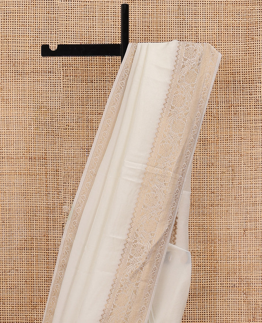 Cream plain design saree, zari border of floral designs, and Mughal-style pallu of zari floral designs