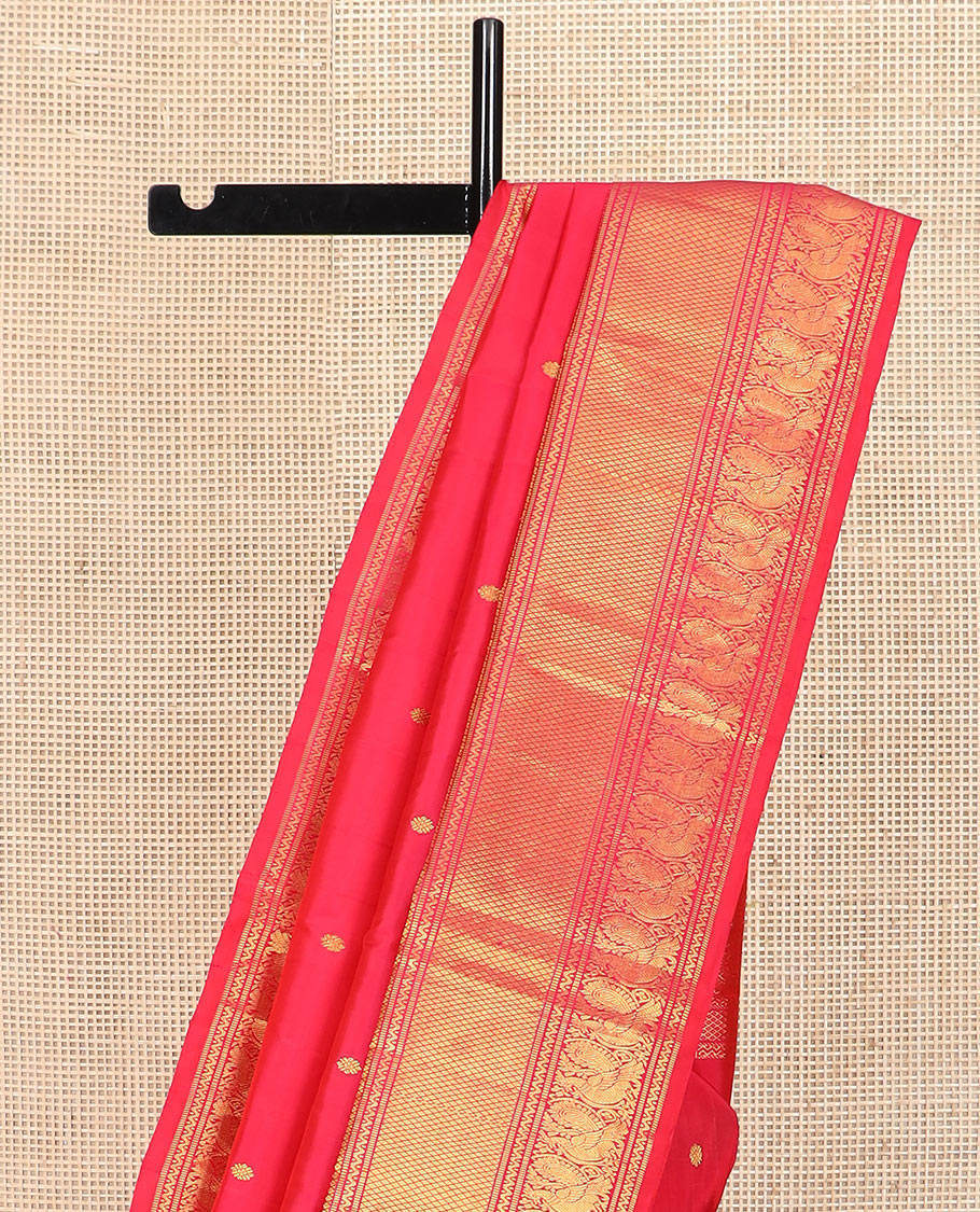 Red zari buttas Kanchipuram silk saree, zari border of muthu, neli, mayil, and mayil kann designs, and chakram design pallu