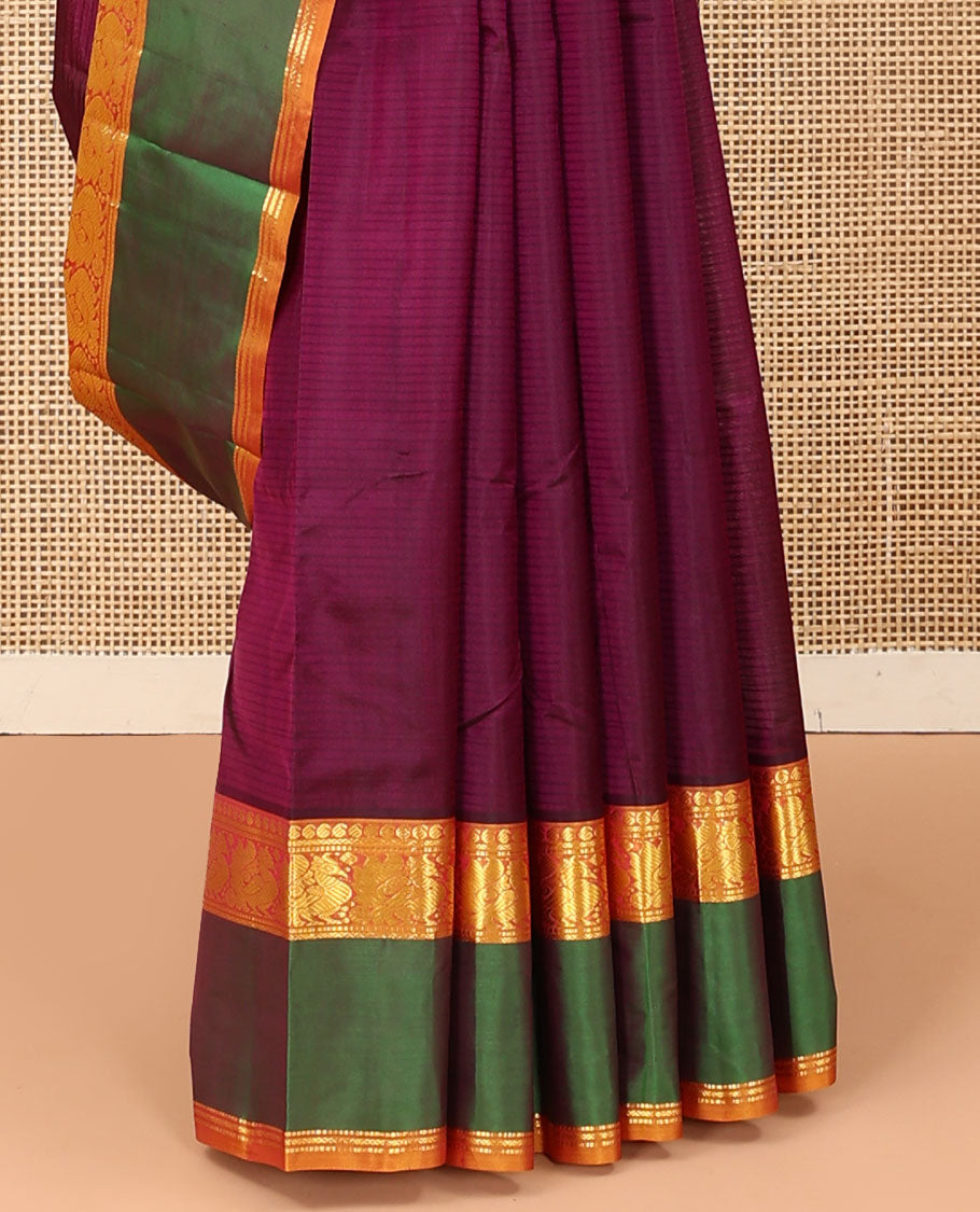 Purple plain Kanchipuram silk saree, contrast rettai pettu border of manga, muthu, and mayil designs, and zari striped pallu