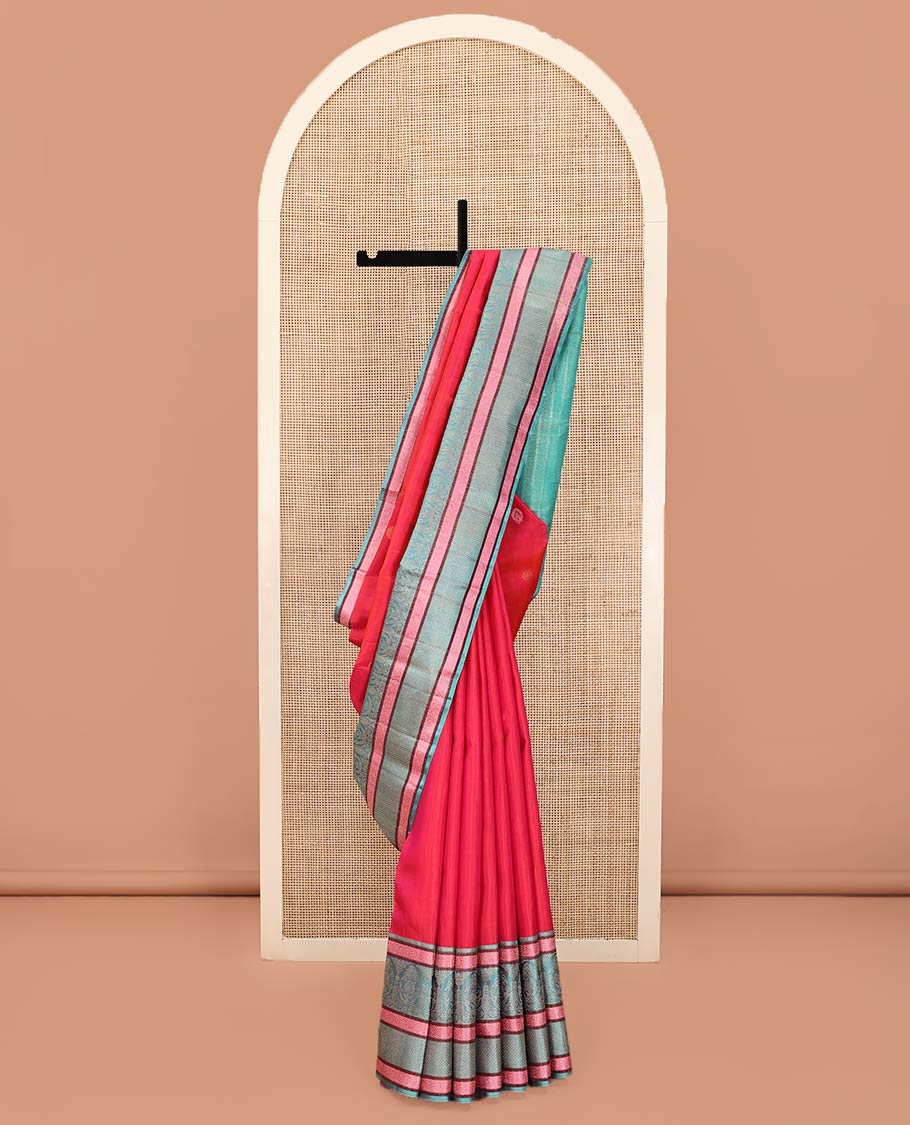 Red Kanchipuram Designer Silk Saree, Subtly Adorned with Buttas All Over Its Body, Complemented by a Captivating Contrast Border of Mughal-Style Designs, Geometric-Patterned Zari-Woven Pallu, and Paired with a Contrast Blouse