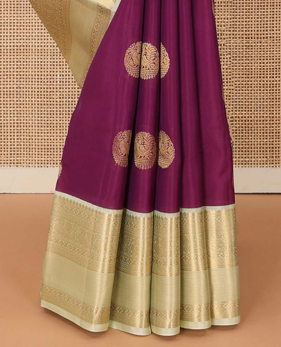 Maroon zari buttas Vasundhara silk mix saree, contrast border of thilakam, muthu, diamond, neli, and mayil designs, and jaal pallu
