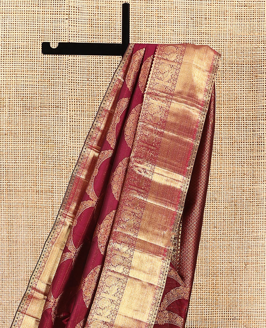 Maroon jacquard kanchipuram silk saree, zari border of thilakam, kodi visiry, and mayil designs, and jaal pallu