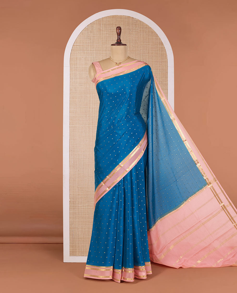 Blue Mysore Silk Saree Delicately Woven with Zari Buttas, Complemented by a Contrast Border Featuring Traditional Zari Designs, Pallu Steeped with Zari Stripes, and Paired with a Contrast Blouse