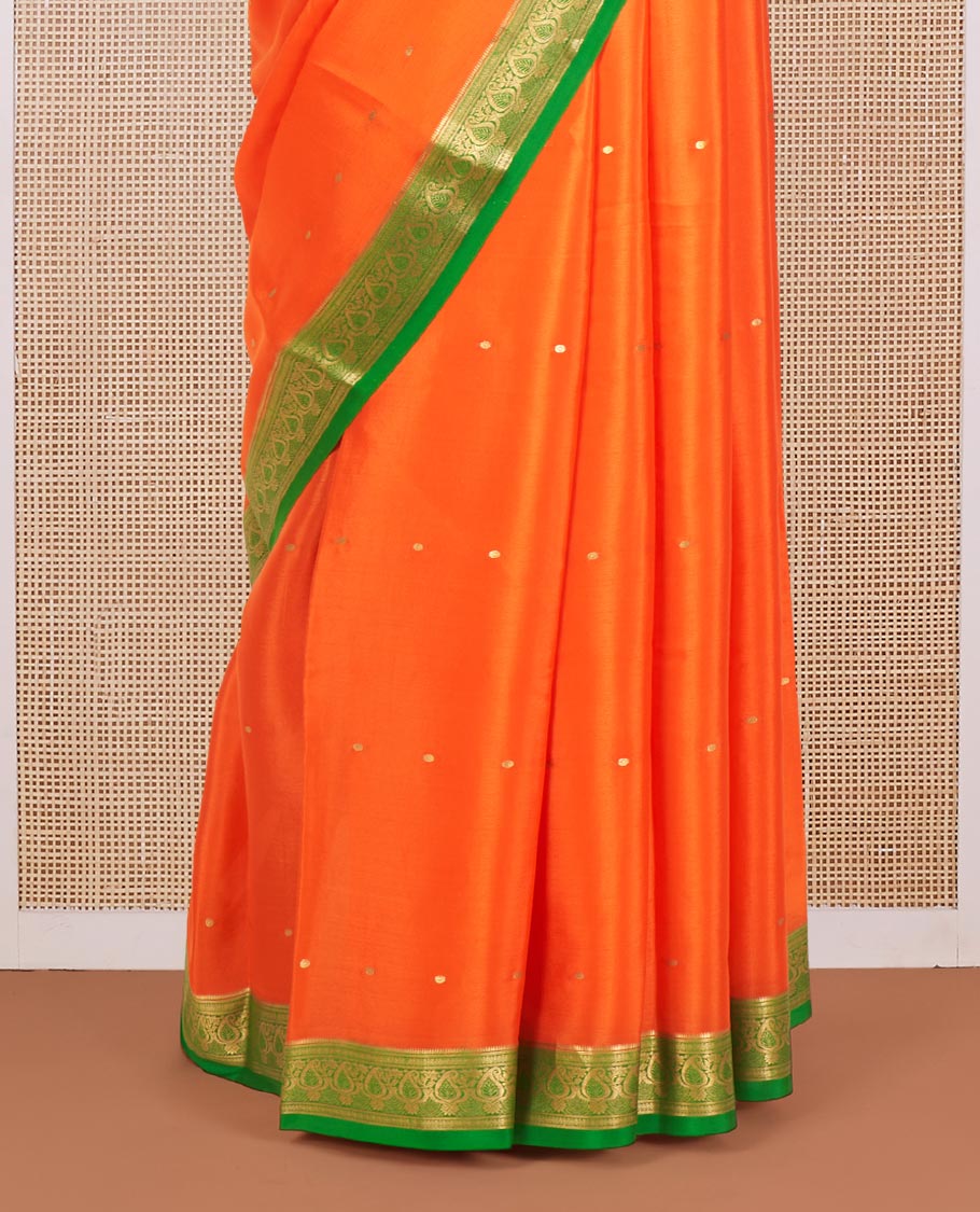 Orange Mysore Silk Saree Enriched with Zari Buttas, Complemented by a Contrast Border Featuring Paisley Zari Designs, Pallu Steeped with Zari Stripes, and Paired with a Contrast Blouse