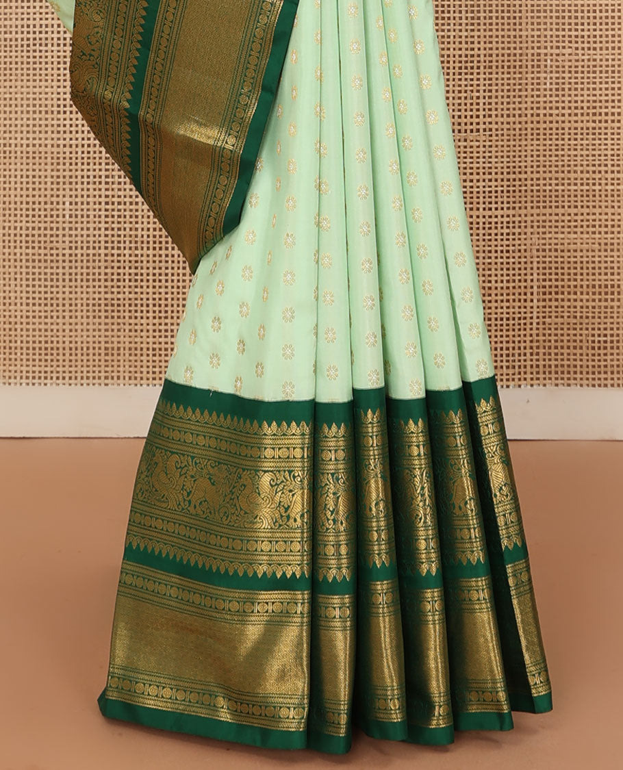 Green kamalam buttas Kanchipuram silk sareee, contrast korvai border of thilakam mokku, kathir, rudraksham, mayil, yaali and jaal design, and zari motifs pallu