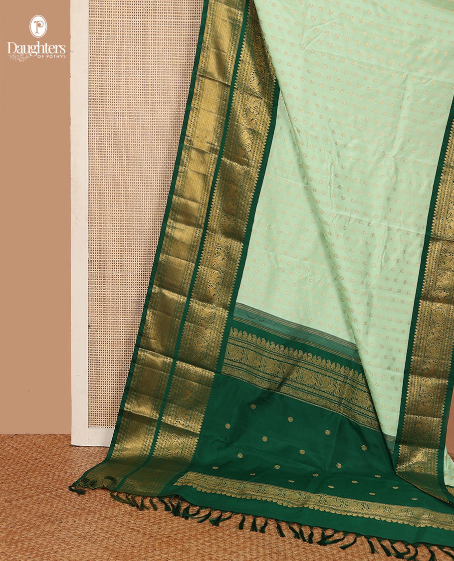 Green kamalam buttas Kanchipuram silk sareee, contrast korvai border of thilakam mokku, kathir, rudraksham, mayil, yaali and jaal design, and zari motifs pallu