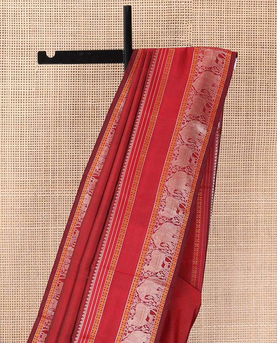 Red thread buttas Kanchipuram silk saree, rettai pettu border of rekku, rudraksham, yaanai, and Pichwai cow designs, and pallu features Vrishabha Kunjara design
