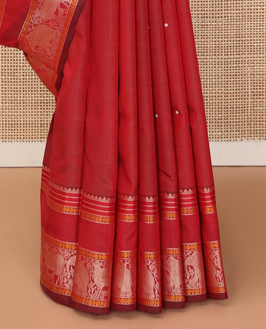 Red thread buttas Kanchipuram silk saree, rettai pettu border of rekku, rudraksham, yaanai, and Pichwai cow designs, and pallu features Vrishabha Kunjara design