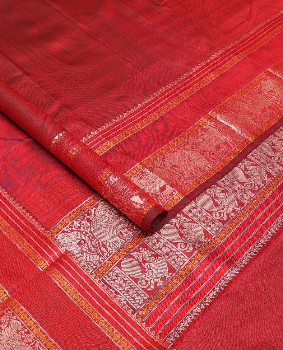 Red thread buttas Kanchipuram silk saree, rettai pettu border of rekku, rudraksham, yaanai, and Pichwai cow designs, and pallu features Vrishabha Kunjara design