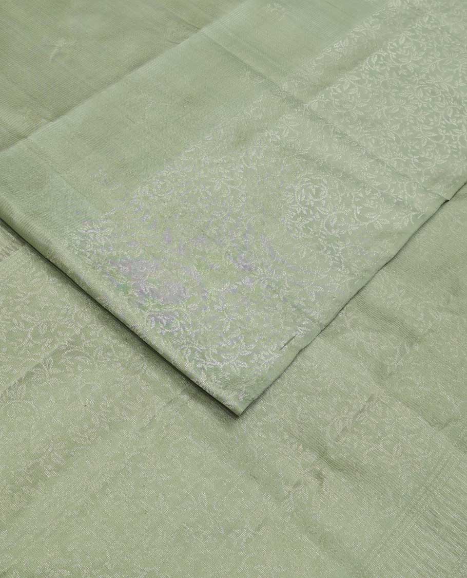 Pastel green floral motifs soft silk saree, floral jaal design border, and pallu of sparesly woven floral jaal design