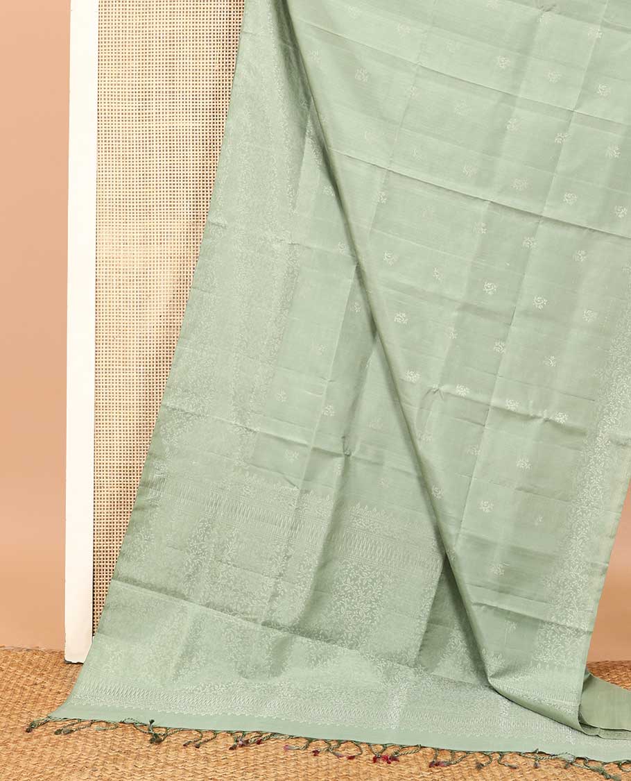 Pastel green floral motifs soft silk saree, floral jaal design border, and pallu of sparesly woven floral jaal design