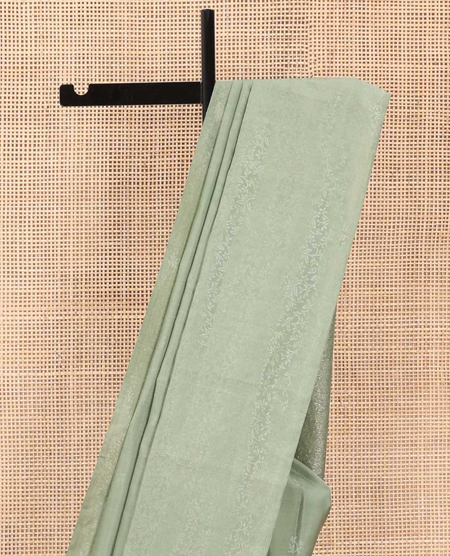 Pastel green floral motifs soft silk saree, floral jaal design border, and pallu of sparesly woven floral jaal design