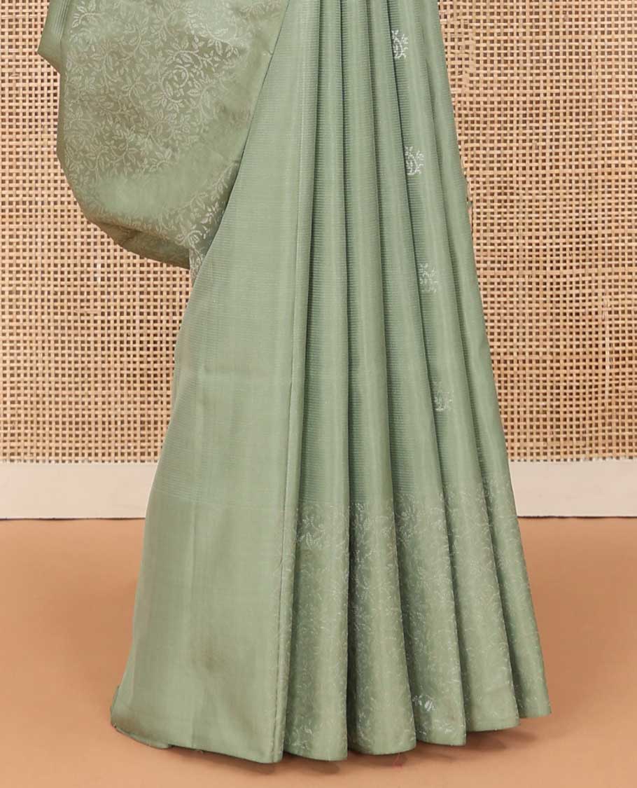 Pastel green floral motifs soft silk saree, floral jaal design border, and pallu of sparesly woven floral jaal design
