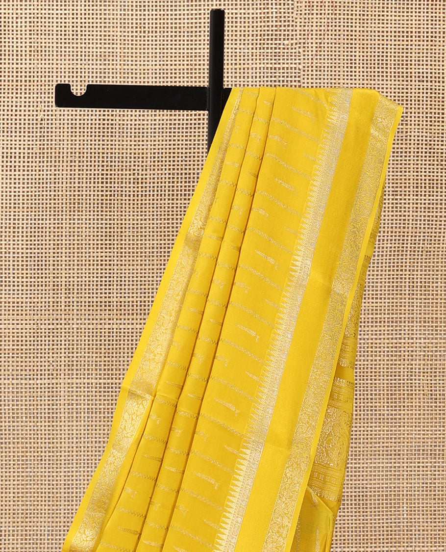 Sandal zari buttas and zig-zag striped crepe saree, traditional zari border, and pallu of traditional design weave