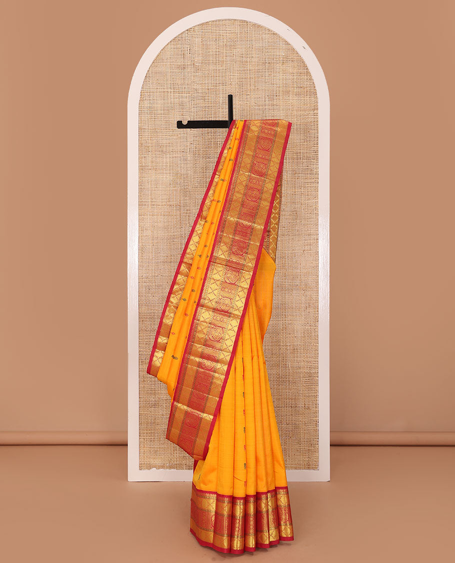 Yellow buttas Kanchipuram silk saree, contrast border of rudraksham, thazampoo rekku, arumbu manga, kathir, diamond, and mayil designs, and jaal pallu