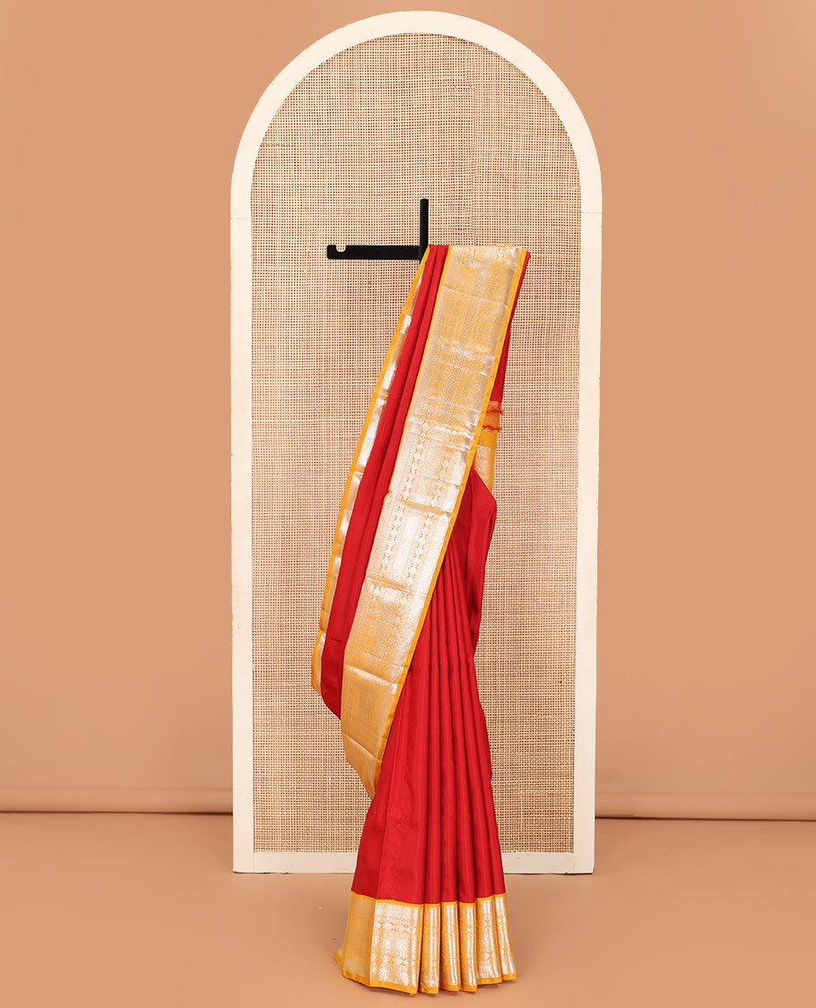 Red plain Kanchipuram silk saree, contrast korvai border of muthu, vanki, neli, rudraksham, and mayil kann, and traditional zari steeped pallu
