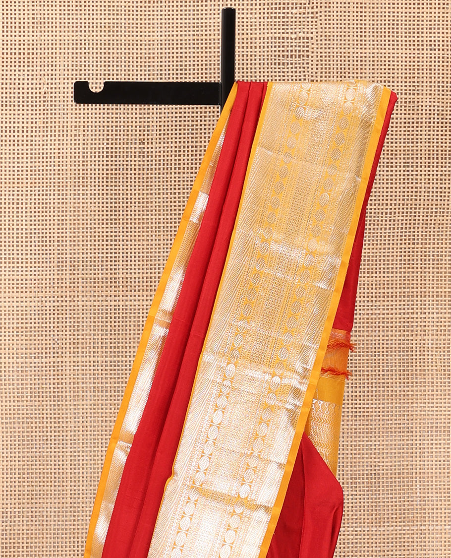 Red plain Kanchipuram silk saree, contrast korvai border of muthu, vanki, neli, rudraksham, and mayil kann, and traditional zari steeped pallu