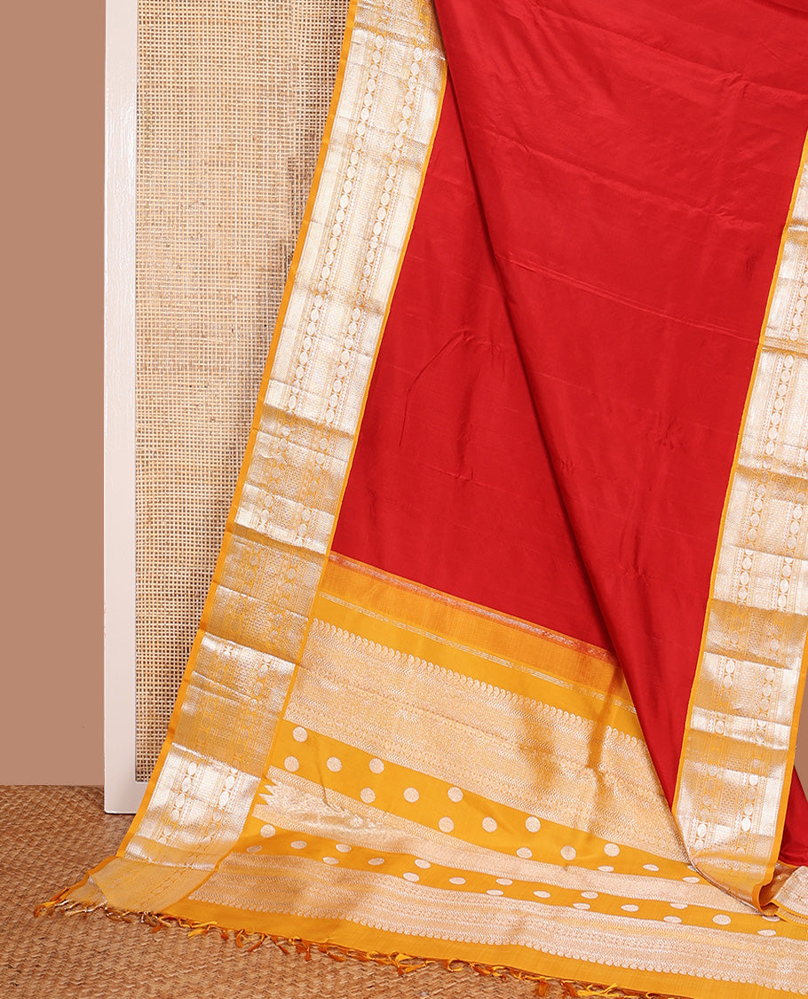 Red plain Kanchipuram silk saree, contrast korvai border of muthu, vanki, neli, rudraksham, and mayil kann, and traditional zari steeped pallu
