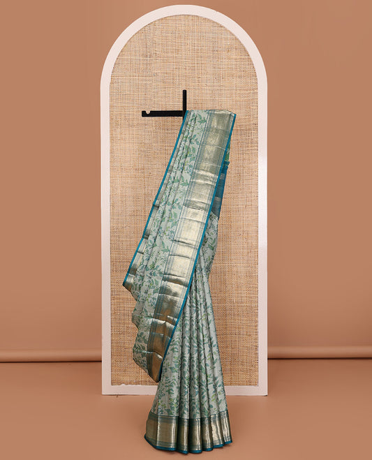 Green leaf printed silk saree, contrast border of thilakam mokku, muthu, diamond, and vanki designs, and jaal pallu