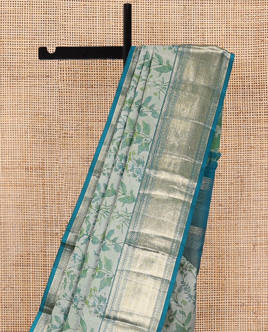 Green leaf printed silk saree, contrast border of thilakam mokku, muthu, diamond, and vanki designs, and jaal pallu