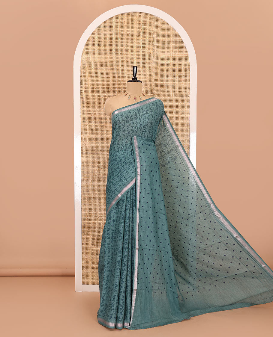 Green tamil letters printed soft cotton saree, zari piping border, small polka dotted pallu, and blouse of abstract and polka dots print