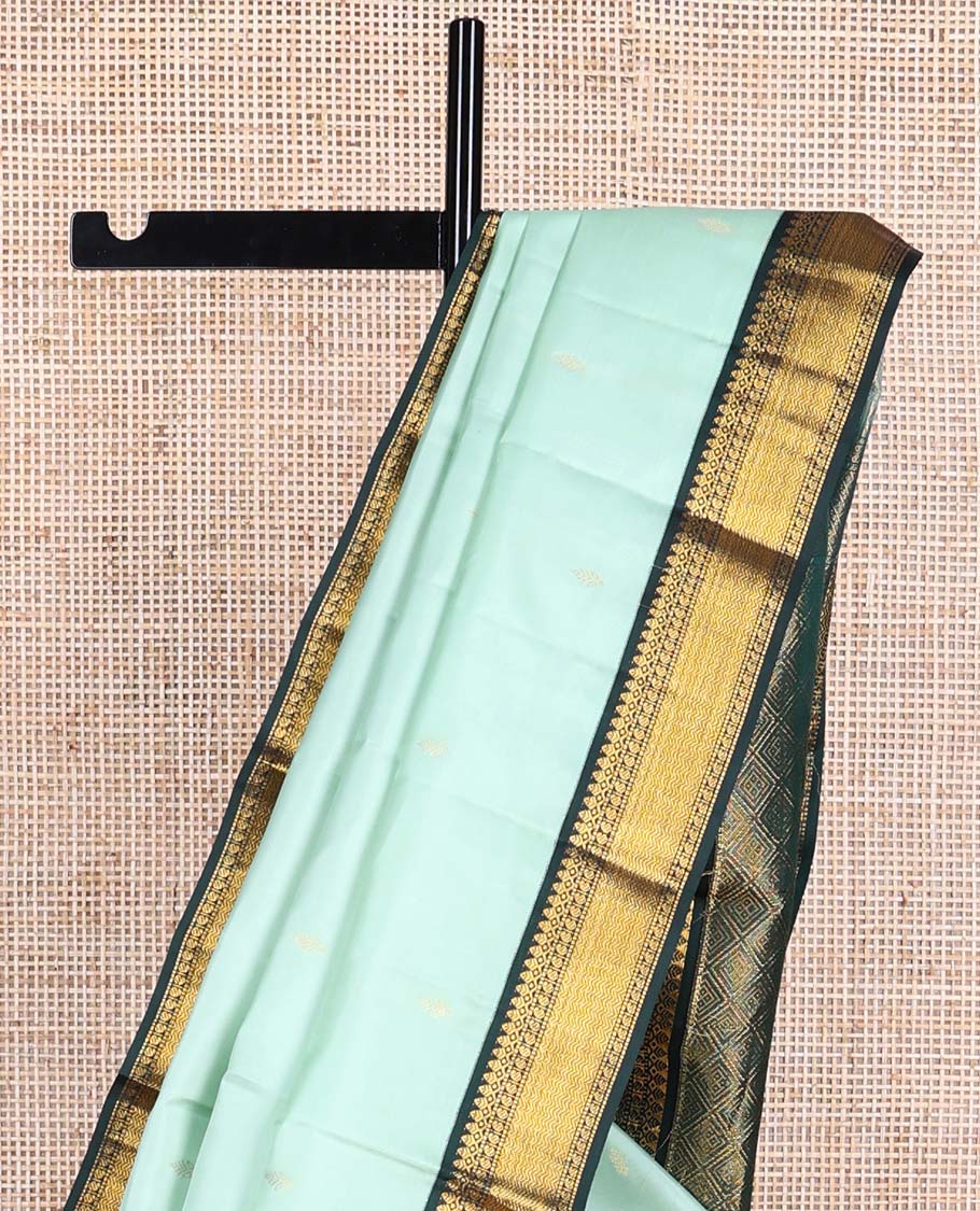 Light blue floral buttas silk saree with contrast border of thilakam mokku, manga, muthu, vanki design & zari design border