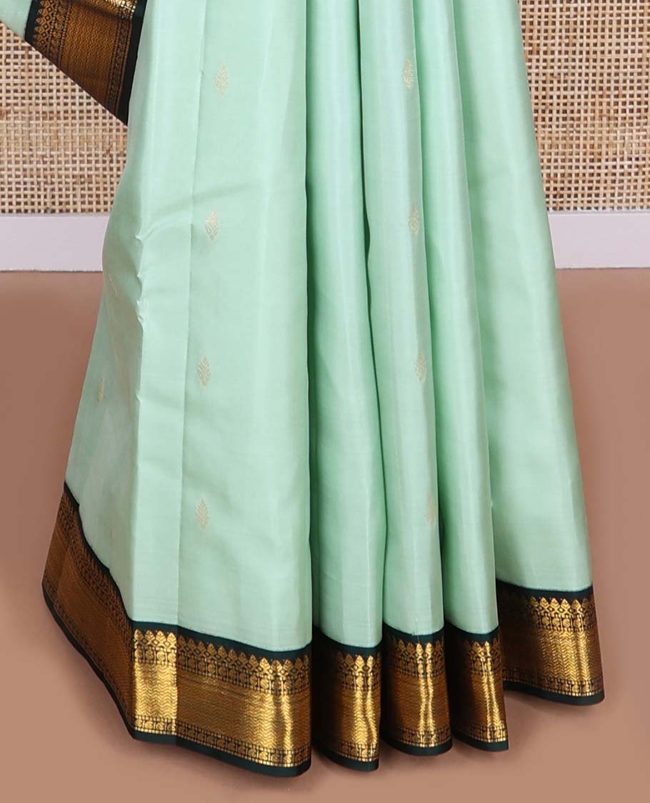 Light blue floral buttas silk saree with contrast border of thilakam mokku, manga, muthu, vanki design & zari design border