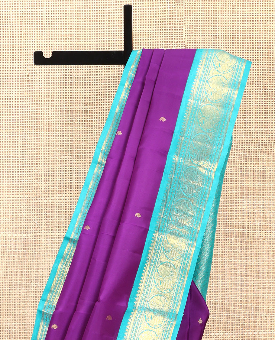 Violet Vasundhara Silk Saree, Subtly Sparkled With Zari Buttas All Over Its Body, Complemented by Zari Buttas All Over Its Body, Complemented by Contrast Border of Thilakam, Banaras, and Mayil Designs Grand Jaal Pallu and Paired with a Contrast Blouse