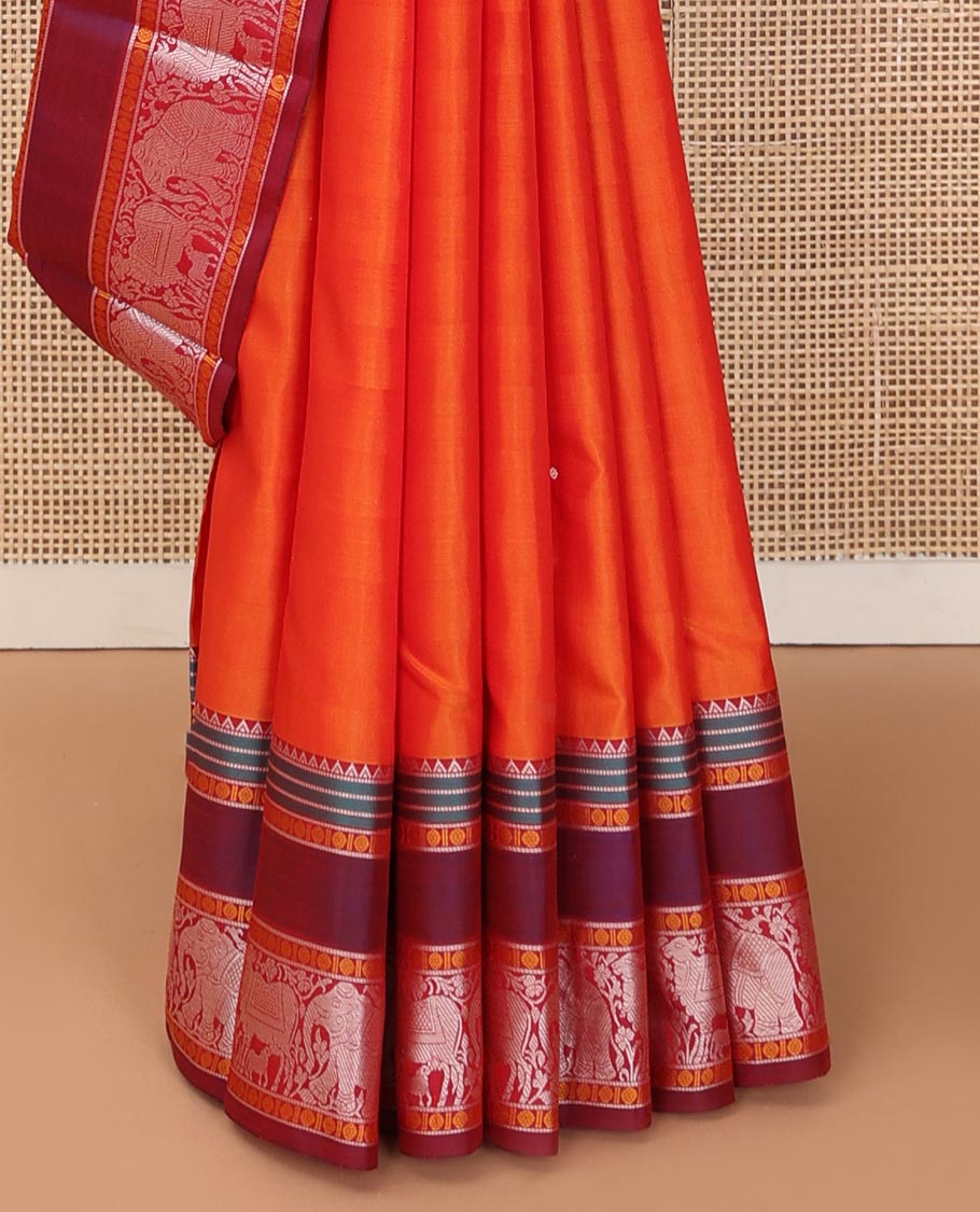 Orange thread buttas Kanchipuram silk saree, contrast rettai pettu border of rekku, rudraksham, yaanai, and Pichwai cow designs, and pallu features Vrishabha Kunjara design