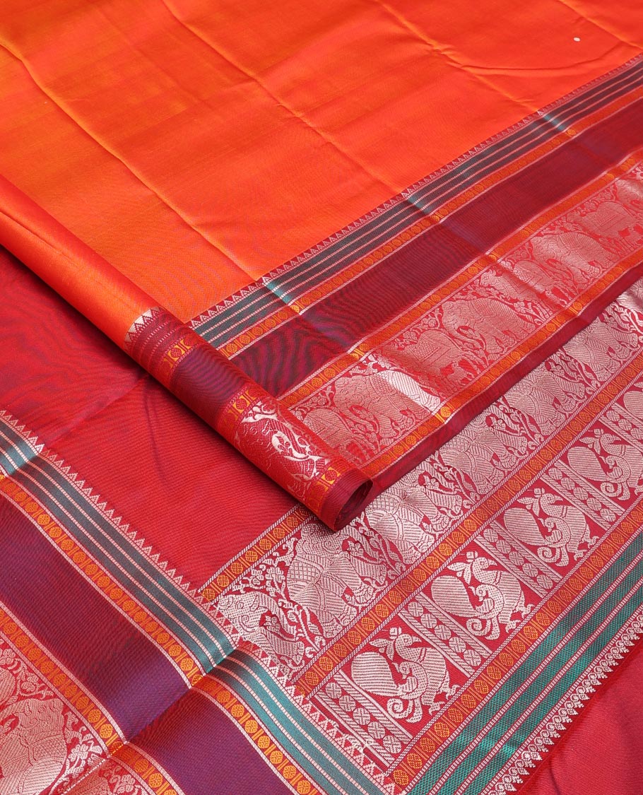 Orange thread buttas Kanchipuram silk saree, contrast rettai pettu border of rekku, rudraksham, yaanai, and Pichwai cow designs, and pallu features Vrishabha Kunjara design