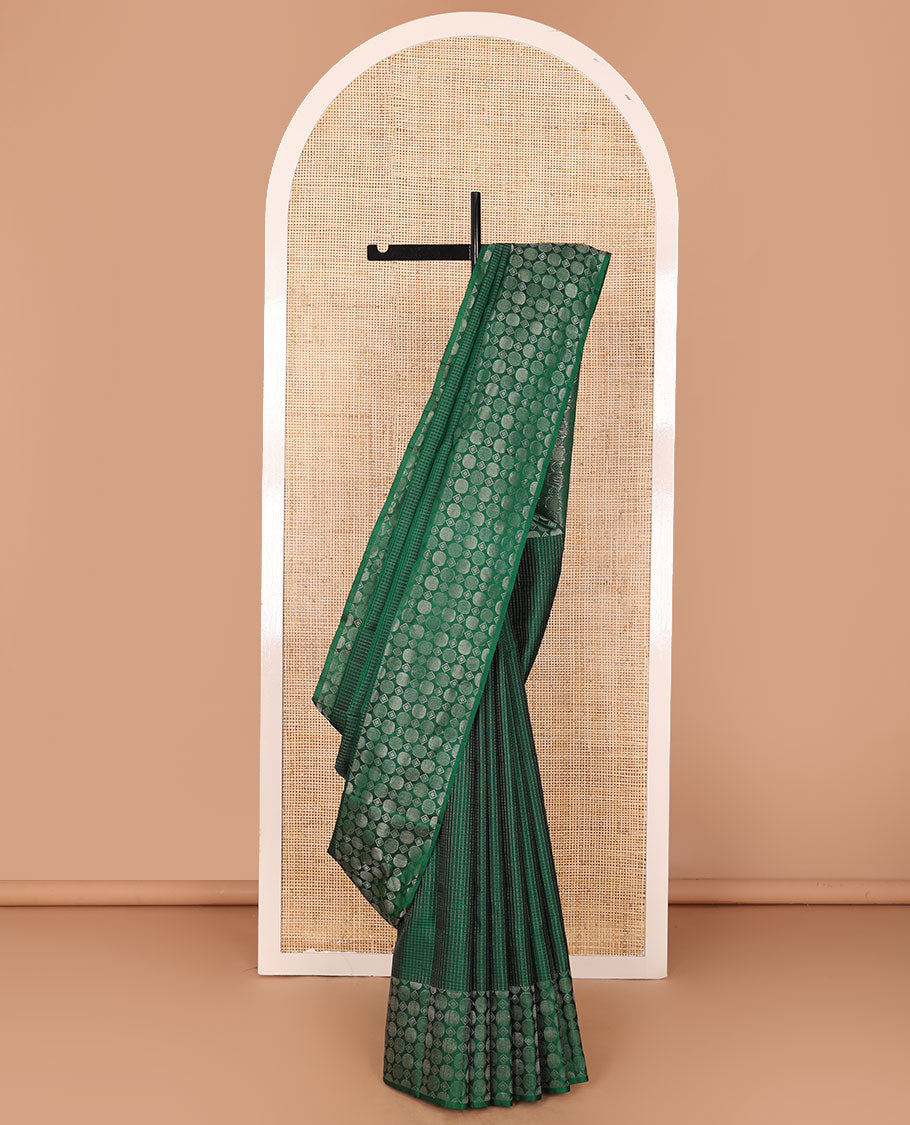 Green muthu kattam soft silk saree, zari border & pallu steeped with geometric-shaped motifs