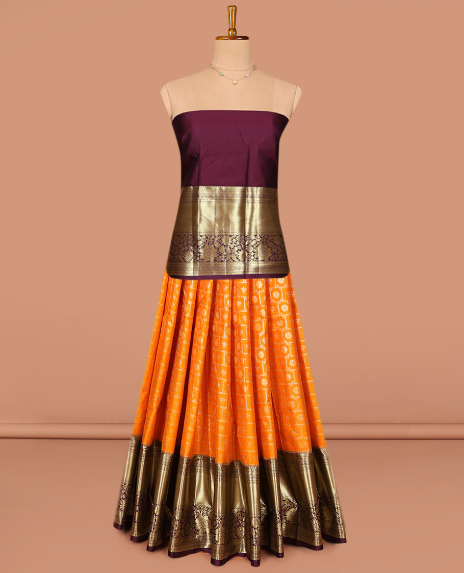 Orange Art Silk Pavadai Material Set, Gleamed Up with Buttas and Checks on Its Skirt, Complemented by a Contrast Traditional Zari Designs Border, and Paired with a Contrast Blouse