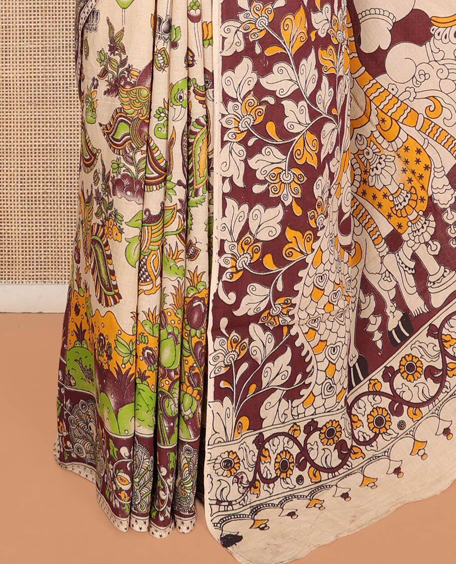 Sandal Machine-Printed Kalamkari Cotton Saree Features Flora-Fauna Motifs, a Contrast Peacock Border, Kalamkari Printed Pallu, and a Matching Blouse