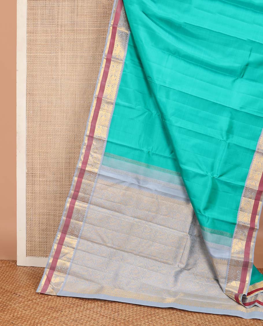 Turquoise plain Kanchipuram korvai silk saree, contrast neer korvai border of rekku, muthu, banaras, and kodi mayil and yaanai designs, and floral jaal pallu